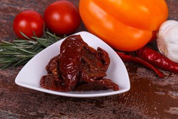 Dried tomatoes in the bowl with olive oil