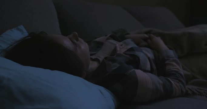 Cinematic close up woman sleeps at night and opens her eyes