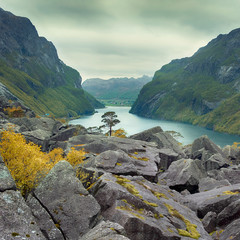 Nature, Norway landscape, Stone heaps on a pass overlooking the blue water of the fjord among green mountains in spring