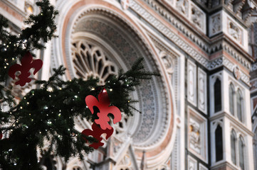 Christmas in Florence. Christmas tree in Piazza del Duomo in Florence with the Cathedral of Santa Maria del Fiore on the background, Italy.