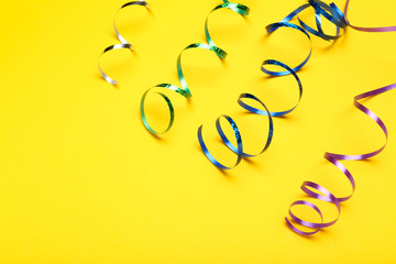 Colorful ribbons on yellow background