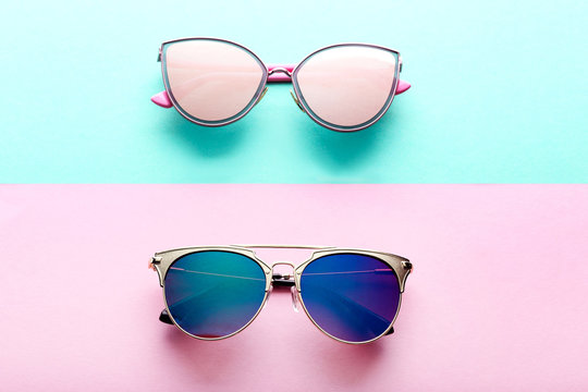 Modern sunglasses on colorful background