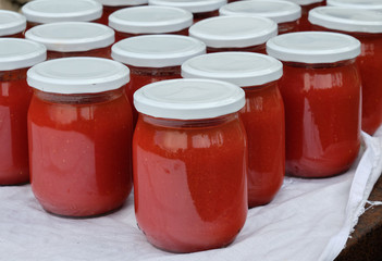 Jars of freshly made tomato puree at an organic farm in Italy.