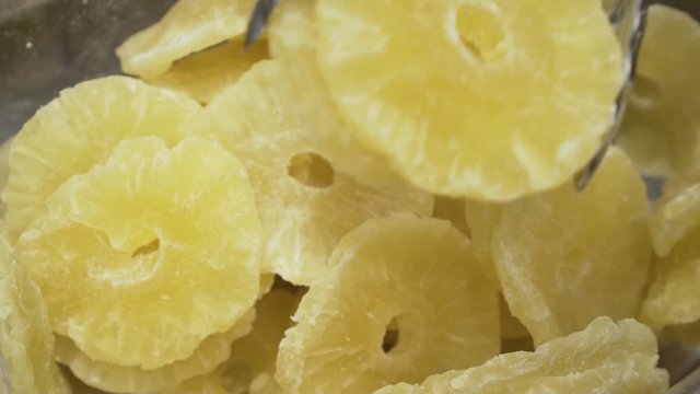 Picking dry pineapple on a farmers market. Slow motion video.