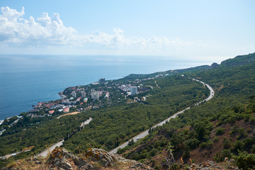 Fototapeta na wymiar Road in the mountains with seascape
