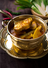 Yellow curry snapper fish with pineapple on wood table,Thai food