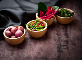 Pepper, chilli, red onion in bowl on wood table,thai kitchen food spice herb