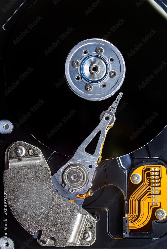 Poster disassembled hard drive from the computer, hdd with mirror effect. opened hard drive from the comput