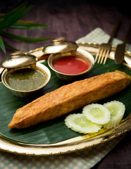 Delicious Crab Omelette and chili sauce on wood table,Thai food