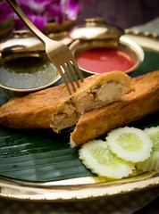 Delicious Crab Omelette and chili sauce on wood table,Thai food