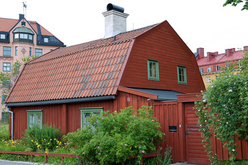 Fototapeta na wymiar Traditional wooden house painted in traditional red located in Stockholm, Sweden
