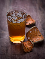 Quince juice with ice herb on wooden background..