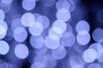 Festive abstract background from highlights on a blue background, Christmas and New Year style, magic illumination from garlands