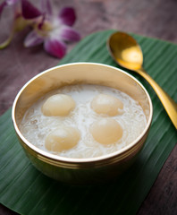Sweet Sticky Rice with Longan and coconut milk on wood,Thai dessert