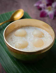 Sweet Sticky Rice with Longan and coconut milk on wood,Thai dessert