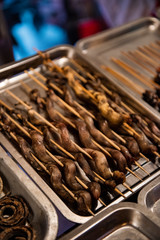 Grilled snakes in a food market in Beijing, China.