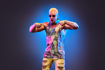 Fashion Excited DJ man dance with expression in neon light. Sexy emotional Handsome pumped-up...