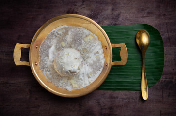 Coconut milk ice cream on brass blow with thai sweet sticky rice