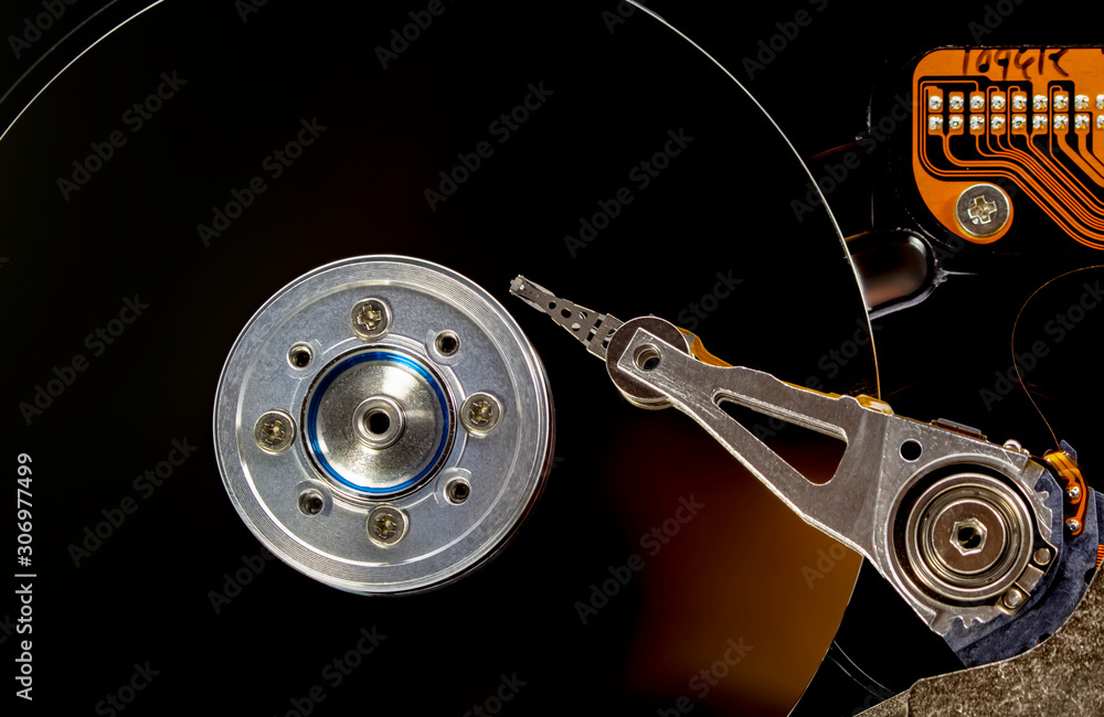 Poster disassembled hard drive from the computer, hdd with mirror effect. opened hard drive from the comput