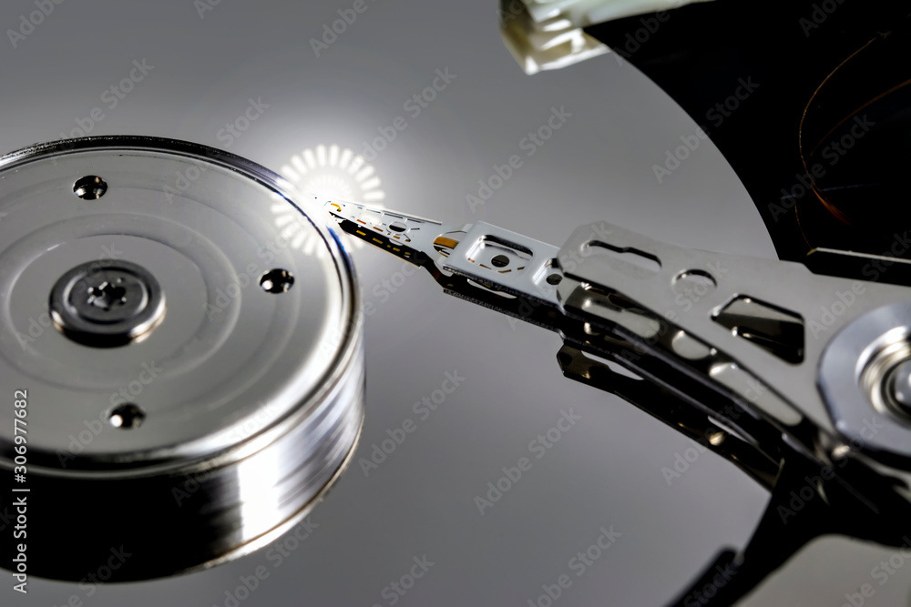 Poster disassembled hard drive from the computer, hdd with mirror effect. opened hard drive from the comput