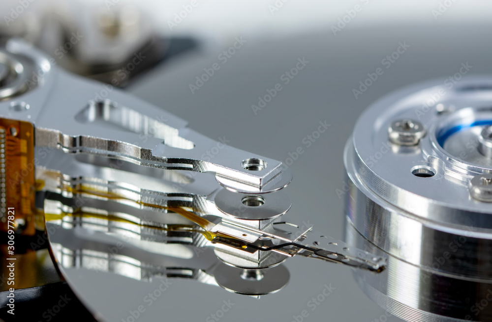 Poster disassembled hard drive from the computer, hdd with mirror effect. opened hard drive from the comput