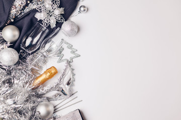 Christmas and New Year white background with champagne, sparklers, silver and golden decorations. Party celebration