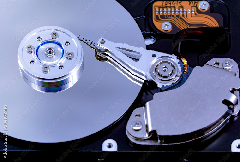 Poster disassembled hard drive from the computer, hdd with mirror effect. opened hard drive from the comput