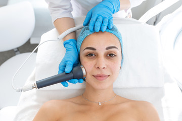 portrait of a young beautiful girl rf face lifting procedure. Face care and rejuvenation. Increased...