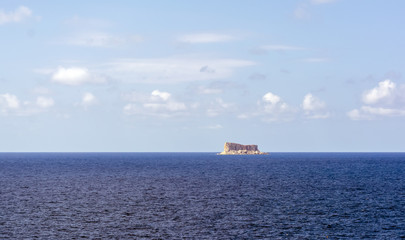 Fototapeta na wymiar Filfla island in tranquil Mediterranean sea. It is a small, barren, uninhabited islet in south of Malta.