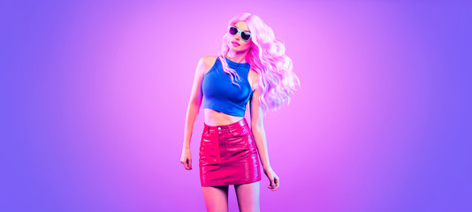Adorable Fashion woman in party outfit dance, Trendy neon light hairstyle. Night club music vibes, gel filter. Excited shapely beautiful sexy girl dancing. Pop Art fashionable creative neon color.