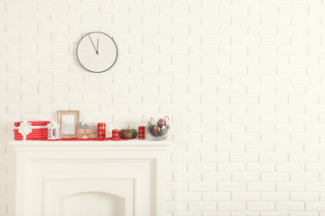 Decorated fireplace for christmas near brick wall at home
