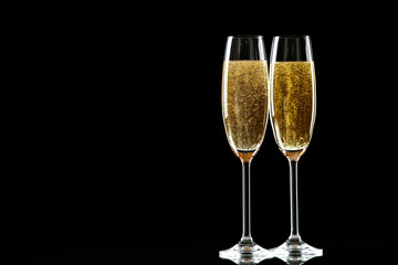 Glasses with champagne on black background