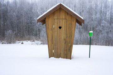 small toilet  in snow in countryside