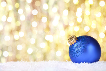 Christmas bauble with white snow on blurred background