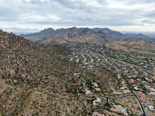Aerial view of upscale luxury homes with dry landscape mountain and desert in Scottsdale, Phoenix,...