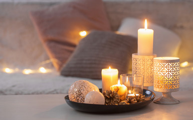 Christmas decoration   with burning candles on  white table agai