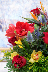 A beautiful bouquet of fresh flowers, roses, orchids, amaryllis on a light background.