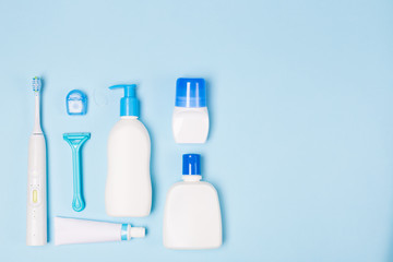 Woman Bath face cleaning care morning routine top view flat lay composition with white and blue items on light blue desk