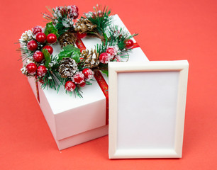Present. Gift box on red background. Christmas wreath. Gift box, frame for your text. gift decoration on red background, top view with copy space