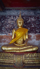 Golden Meditating Buddha Statues Sitting In Corridor