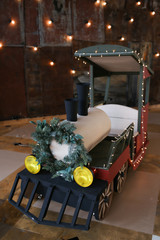 Christmas locomotive, children's toy decorated with garlands