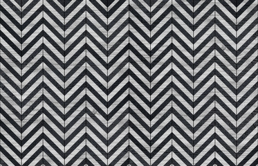 Black and white wooden tile with geometric pattern.	