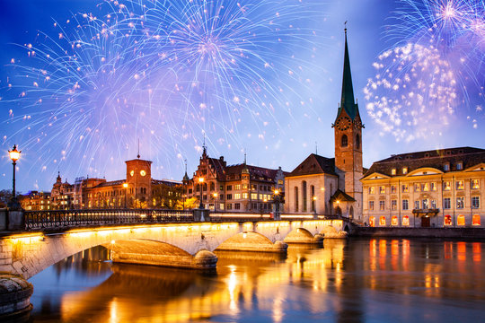 new year fireworks over Zurich city center with famous Fraumunster and Grossmunster Churches and river Limmat at Lake Zurich, Canton of Zurich, Switzerland