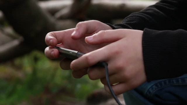 teenager's hands holding smartphone