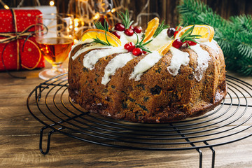 Christmas fruit cake, pudding on rustic wooden background. New Year pastries. Holidays Concept. Top view. Flat lay