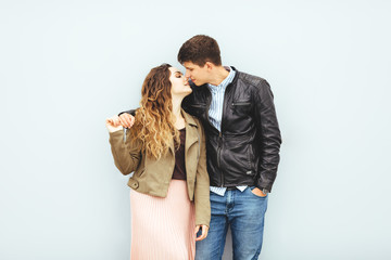 Happy loving couple isolated on gray background. stylish image, good mood, kiss in love