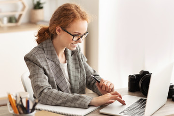 Woman reporter working with laptop and camera