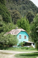Fototapeta na wymiar Turquoise house in the trees