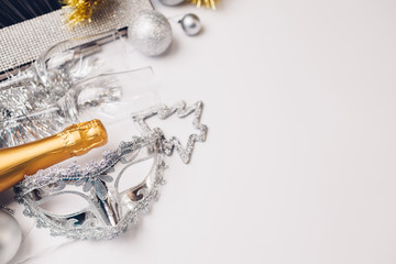 Christmas and New Year white background with champagne, silver and golden decorations. Party...