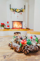 Christmas decorations in living room with burning fireplace 